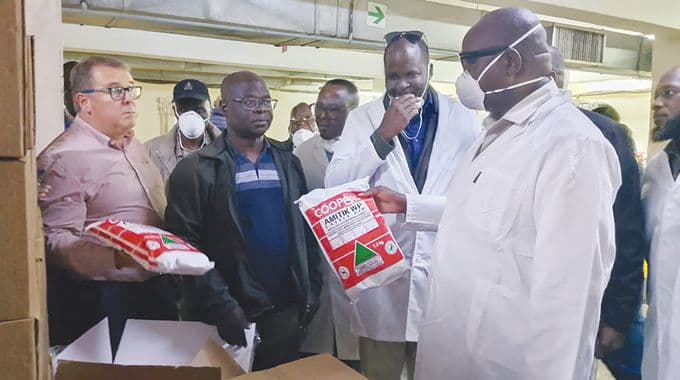 Deputy Minister Davis Marapira inspecting livestock dipping chemicals at Coopers Zimbabwe in Bulawayo.
